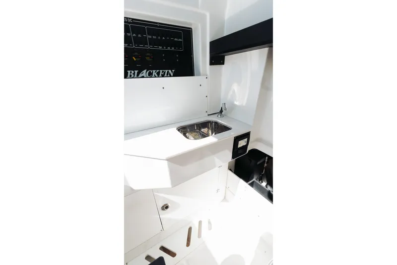 Slide: The Image of Interior view of 2021 Blackfin 332 CC boat featuring a compact sink area. - 25