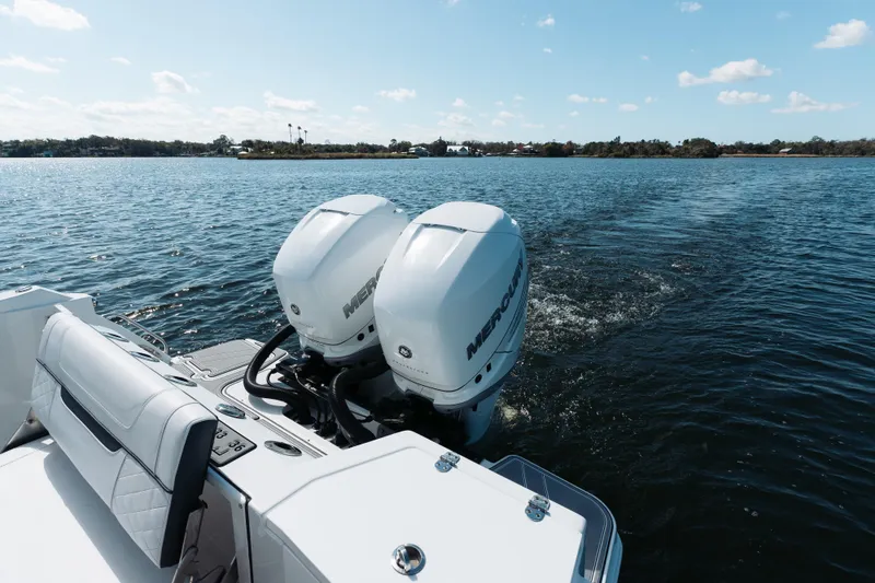 Slide: The Image of 2021 Blackfin 332 CC boat with dual Mercury engines on a calm lake. - 29