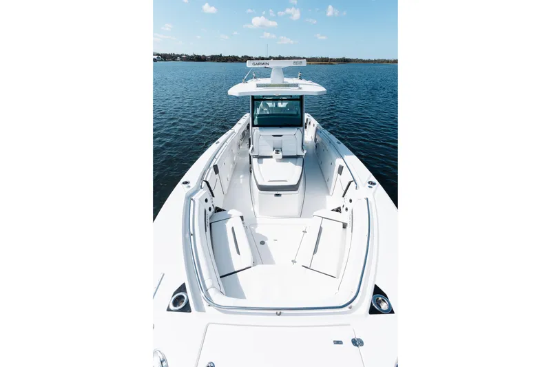 Slide: The Image of 2021 Blackfin 332 CC boat on water, featuring spacious deck and modern design. - 31