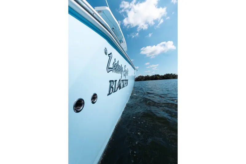 Slide: The Image of 2021 Blackfin 332 CC boat on water under blue sky. - 34