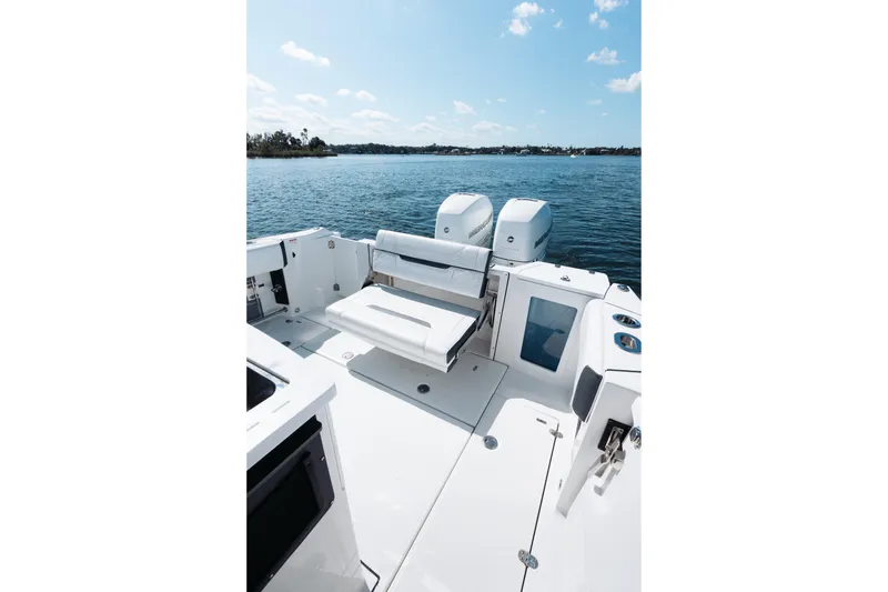 Slide: The Image of 2021 Blackfin 332 CC boat interior with seating, on a sunny day by the water. - 35