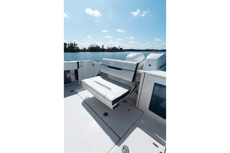 Slide: The Image of 2021 Blackfin 332 CC boat with seating, on a sunny day by the water. - 37