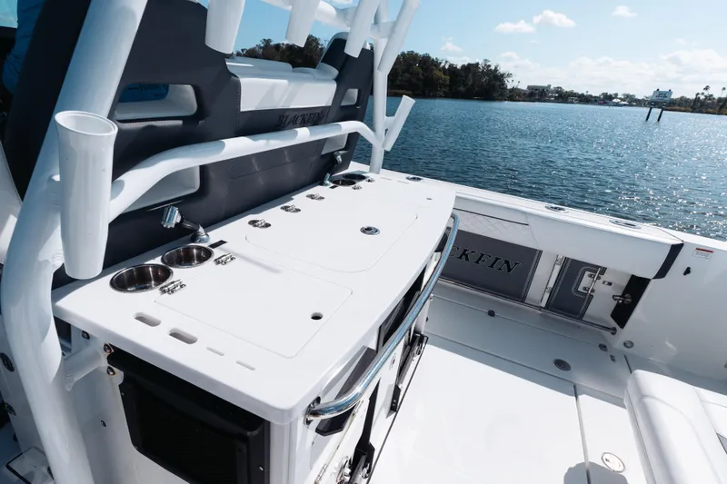 Slide: The Image of 2021 Blackfin 332 CC boat interior with fishing rod holders and ocean view. - 39