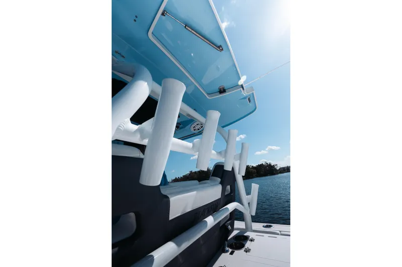 Slide: The Image of 2021 Blackfin 332 CC boat with rod holders, under a clear blue sky. - 41