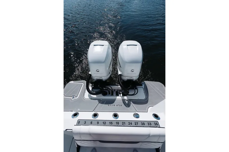 Slide: The Image of 2021 Blackfin 332 CC boat with dual outboard engines on open water. - 45