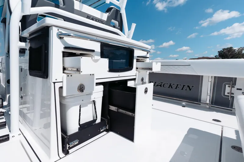 Slide: The Image of 2021 Blackfin 332 CC boat interior with storage compartments and seating. - 49