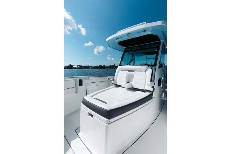 Slide: The Image of 2021 Blackfin 332 CC boat with sleek seating, under a clear blue sky. - 5
