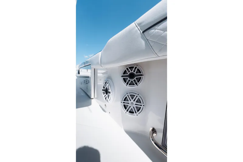 Slide: The Image of 2021 Blackfin 332 CC boat speakers and seating under clear blue sky. - 51