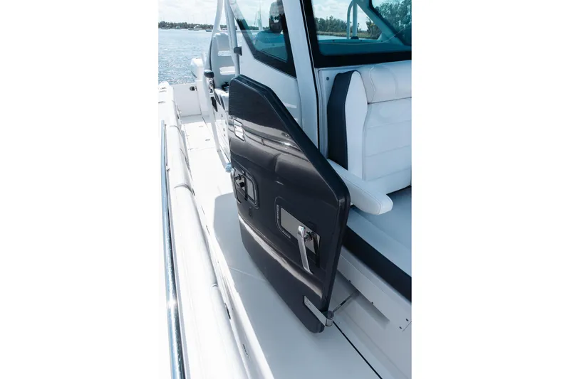 Slide: The Image of 2021 Blackfin 332 CC boat with open side door, white seating, and ocean view. - 66