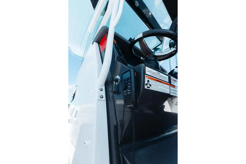 Slide: The Image of 2021 Blackfin 332 CC boat helm with steering wheel and control panel. - 68