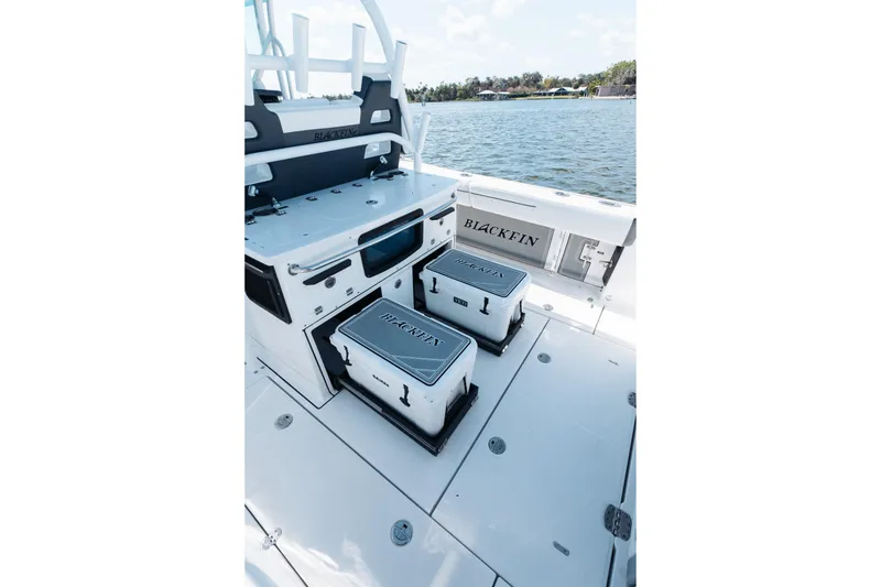 Slide: The Image of 2021 Blackfin 332 CC boat interior with storage and seating, near water. - 73