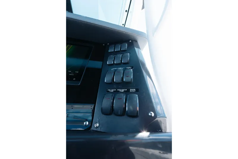 Slide: The Image of Control panel of 2021 Blackfin 332 CC boat with switches and display screen. - 77