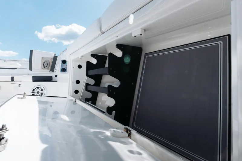 Slide: The Image of 2021 Blackfin 332 CC boat interior with storage compartments and seating under a clear sky. - 79