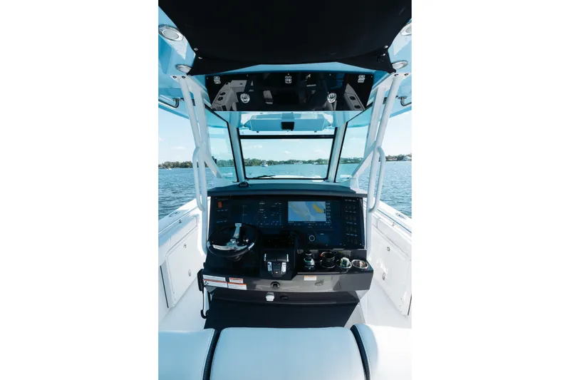 Slide: The Image of 2021 Blackfin 332 CC boat helm with advanced navigation system on open water. - 8