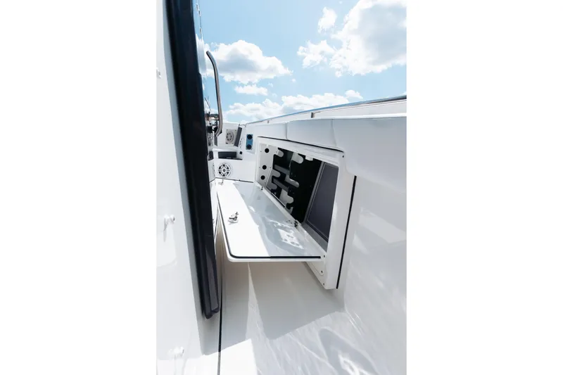 Slide: The Image of 2021 Blackfin 332 CC boat storage compartment under a clear blue sky. - 81