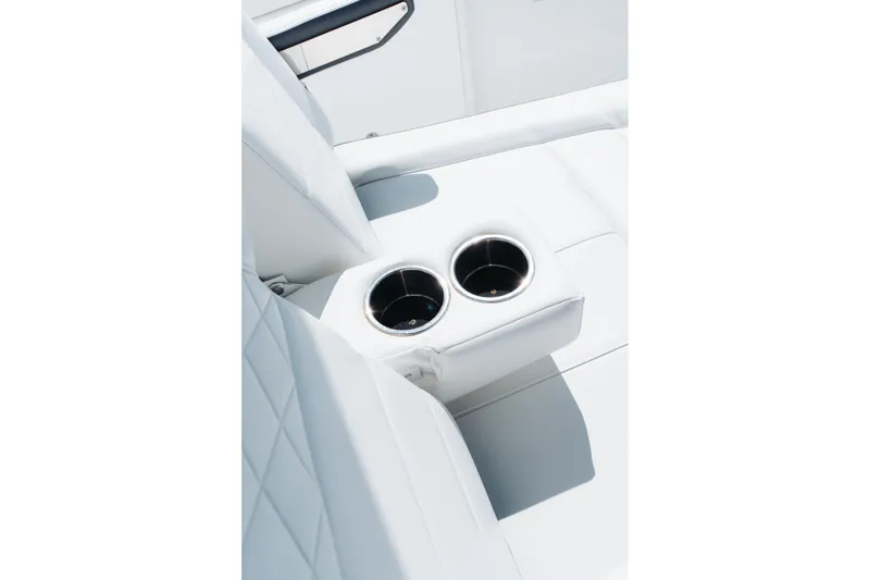Slide: The Image of White leather seating with dual cup holders on a 2021 Blackfin 332 CC boat. - 83