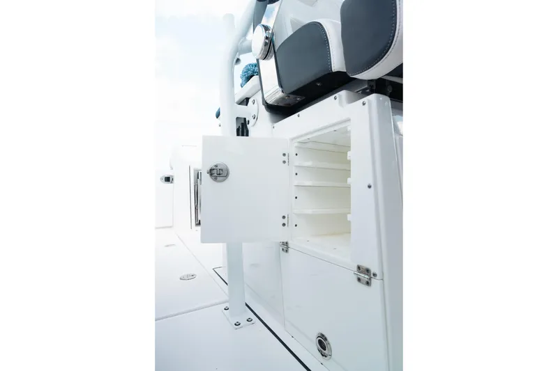 Slide: The Image of 2021 Blackfin 332 CC boat interior storage compartment with open door and seating. - 85