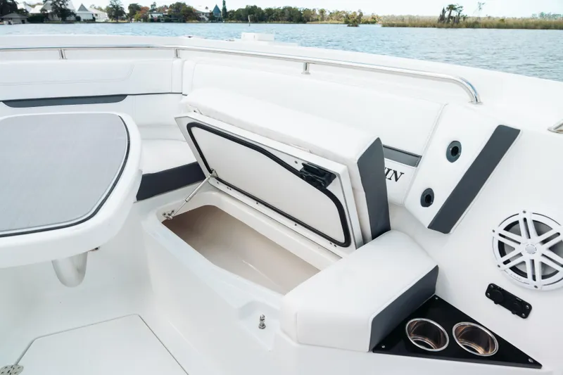 Slide: The Image of 2021 Blackfin 332 CC boat interior with open storage compartment and cup holders. - 86