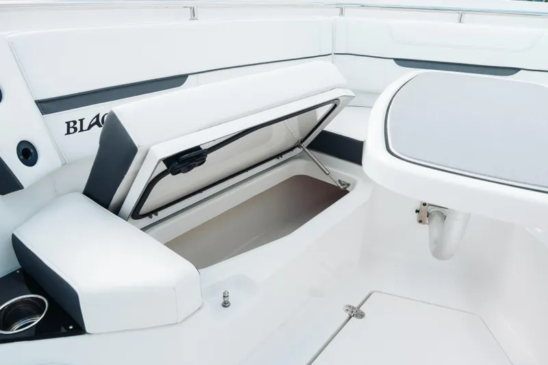 Slide: The Image of 2021 Blackfin 332 CC boat interior with open storage compartment and seating area. - 87
