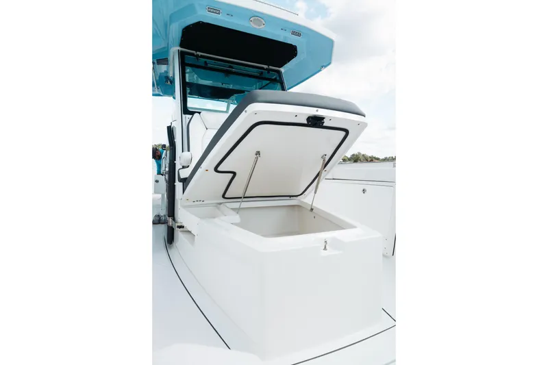 Slide: The Image of 2021 Blackfin 332 CC boat with open storage compartment, showcasing sleek design. - 88