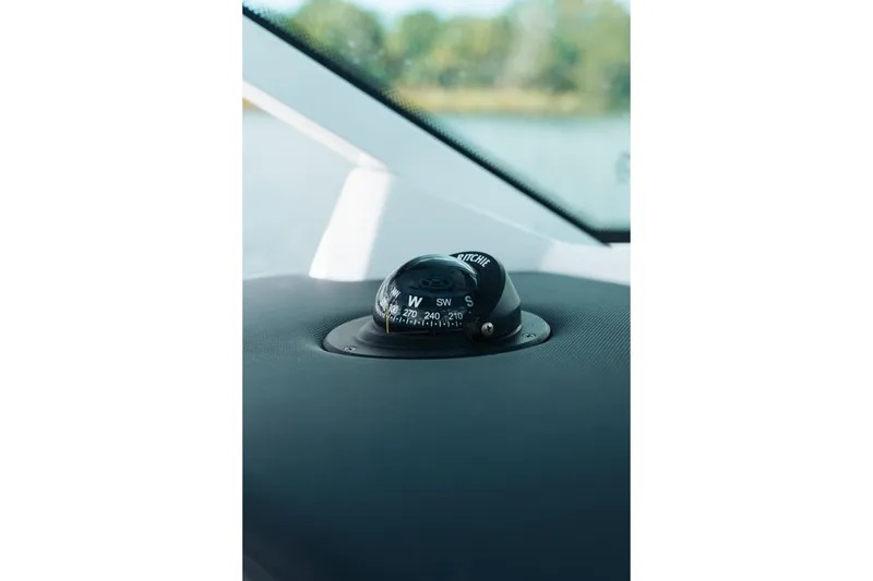 Slide: The Image of Compass on 2021 Blackfin 332 CC boat dashboard, close-up view. - 97