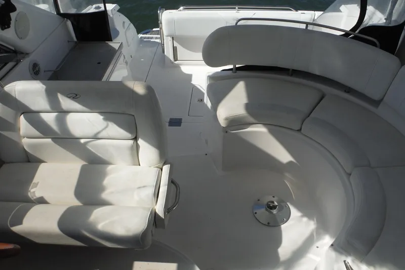 Slide: The Image of 2008 Regal Commodore 3760 IO boat interior with white seating and circular layout. - 10