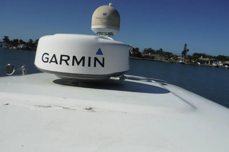 Slide: The Image of 2008 Regal Commodore 3760 IO boat with Garmin radar on deck, near waterfront homes. - 13