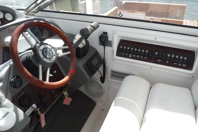 Slide: The Image of 2008 Regal Commodore 3760 IO boat cockpit with steering wheel and control panel. - 16
