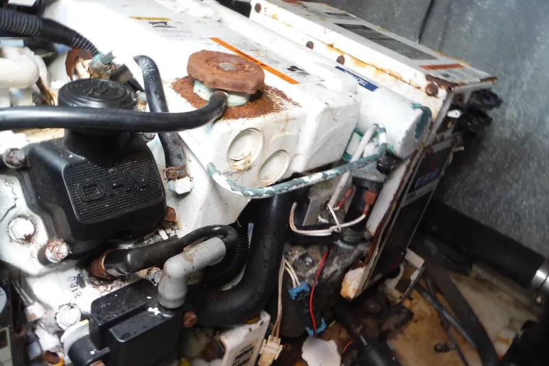 Slide: The Image of 2008 Regal Commodore 3760 IO engine compartment with visible rust and wiring. - 25