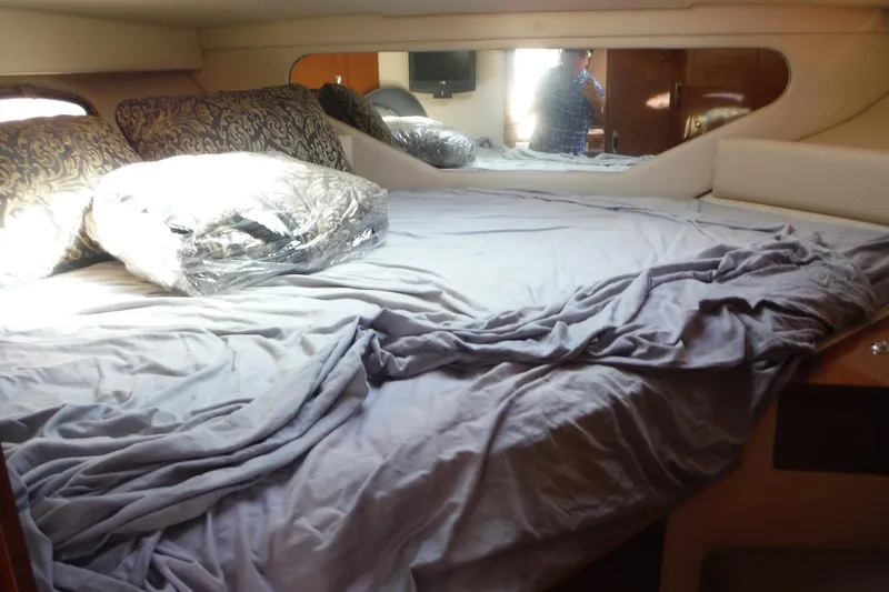 Slide: The Image of Cozy cabin interior of 2008 Regal Commodore 3760 IO with bed and pillows. - 31