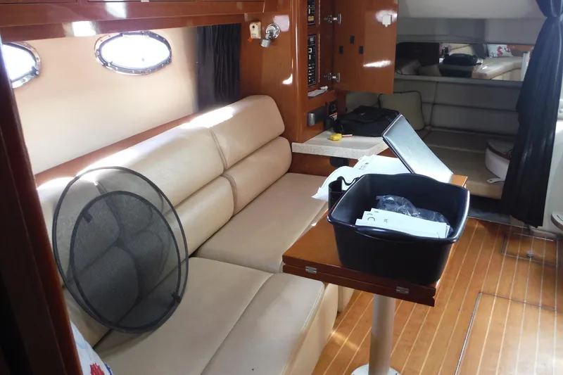 Slide: The Image of Interior of 2008 Regal Commodore 3760 IO yacht with beige seating and wooden accents. - 32