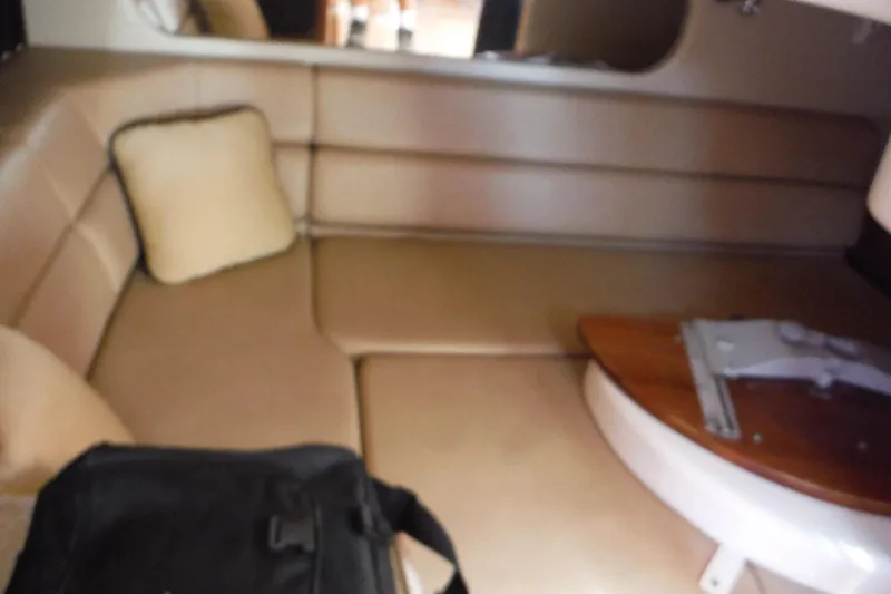 Slide: The Image of 2008 Regal Commodore 3760 IO cabin interior with beige seating and wooden table. - 35