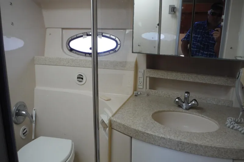 Slide: The Image of 2008 Regal Commodore 3760 IO yacht bathroom with sink, toilet, and mirror cabinet. - 38