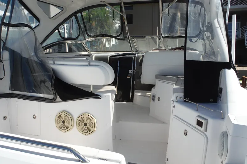 Slide: The Image of 2008 Regal Commodore 3760 IO boat interior with white seating and clear enclosures. - 42