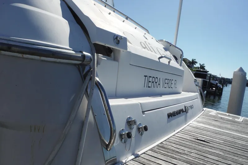 Slide: The Image of 2008 Regal Commodore 3760 IO docked at marina, featuring sleek design and "Tierra Verde, FL" text. - 46