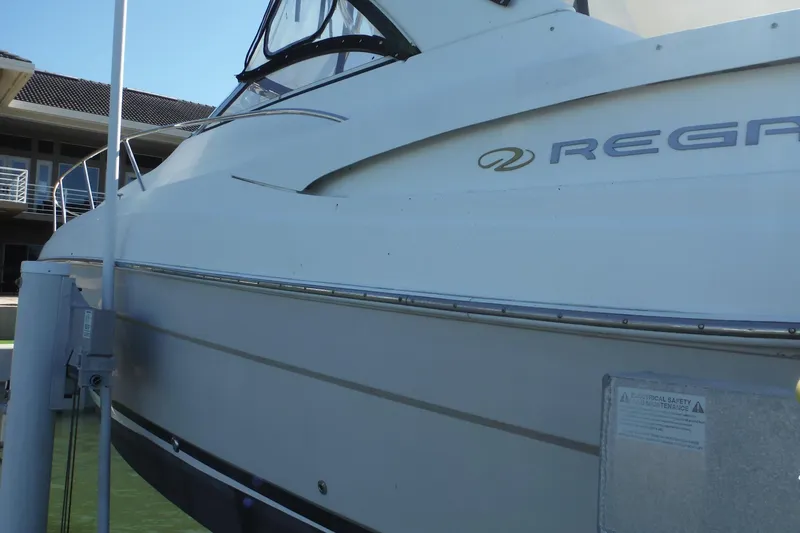 Slide: The Image of 2008 Regal Commodore 3760 IO boat docked near a modern building. - 47