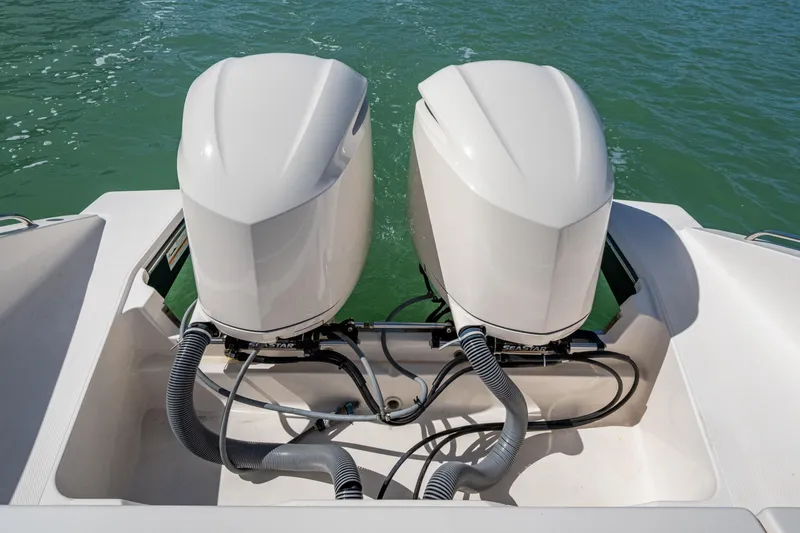 Slide: The Image of 2017 Pursuit DC 295 Dual Console boat with twin outboard engines on water. - 27