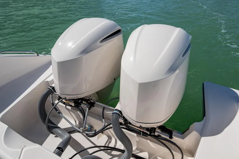 Slide: The Image of 2017 Pursuit DC 295 Dual Console boat with twin outboard engines on water. - 28