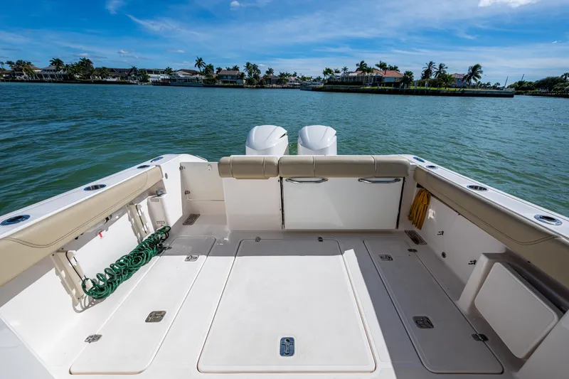 Slide: The Image of 2017 Pursuit DC 295 Dual Console boat on calm water, spacious deck view. - 29