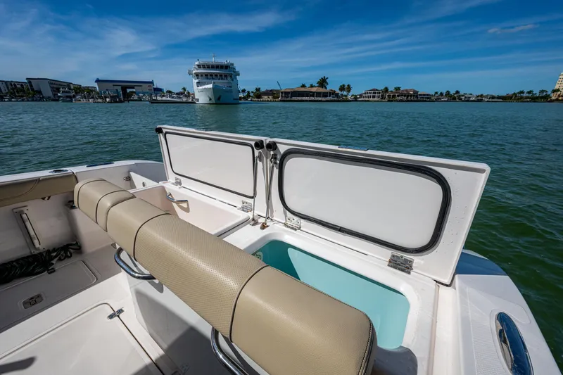 Slide: The Image of 2017 Pursuit DC 295 Dual Console boat on water, open storage, scenic marina view. - 31