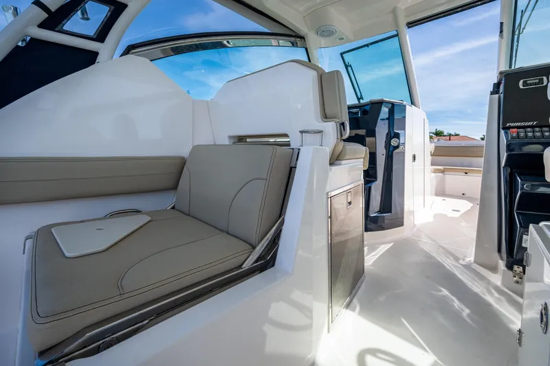 Slide: The Image of 2017 Pursuit DC 295 Dual Console interior with seating and helm, showcasing modern design. - 36