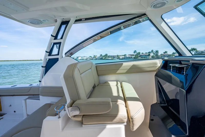 Slide: The Image of 2017 Pursuit DC 295 Dual Console interior with beige seating and ocean view. - 39