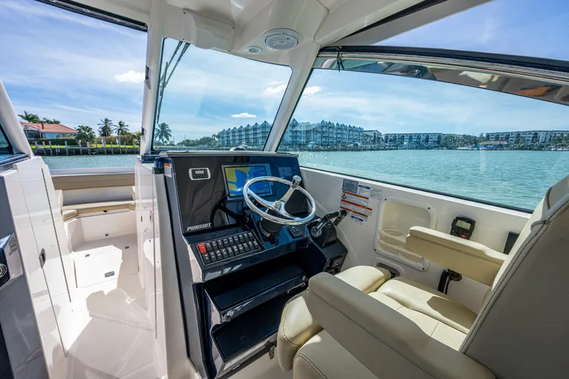 Slide: The Image of 2017 Pursuit DC 295 Dual Console boat interior with steering wheel and navigation system. - 42