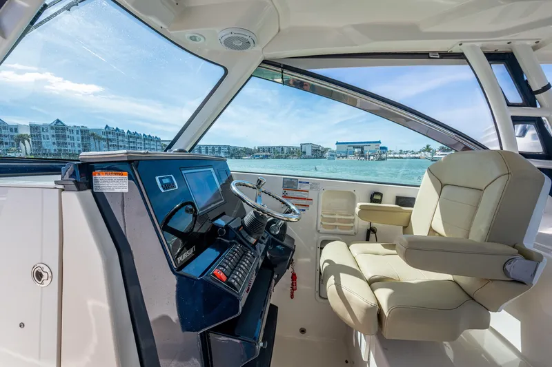 Slide: The Image of 2017 Pursuit DC 295 Dual Console boat interior with helm and luxurious seating. - 44