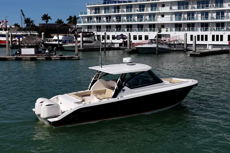 Slide: The Image of 2017 Pursuit DC 295 Dual Console boat docked in marina, sunny day. - 51