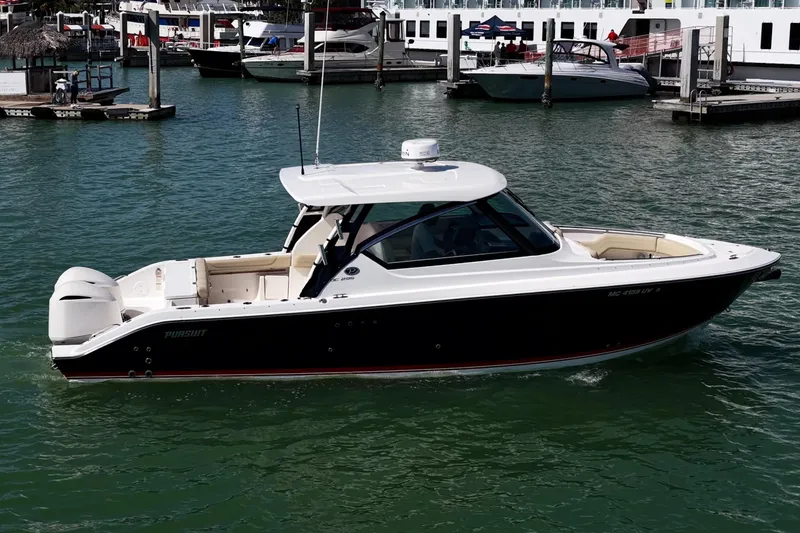 Slide: The Image of 2017 Pursuit DC 295 Dual Console boat docked in marina, calm waters, sunny day. - 52