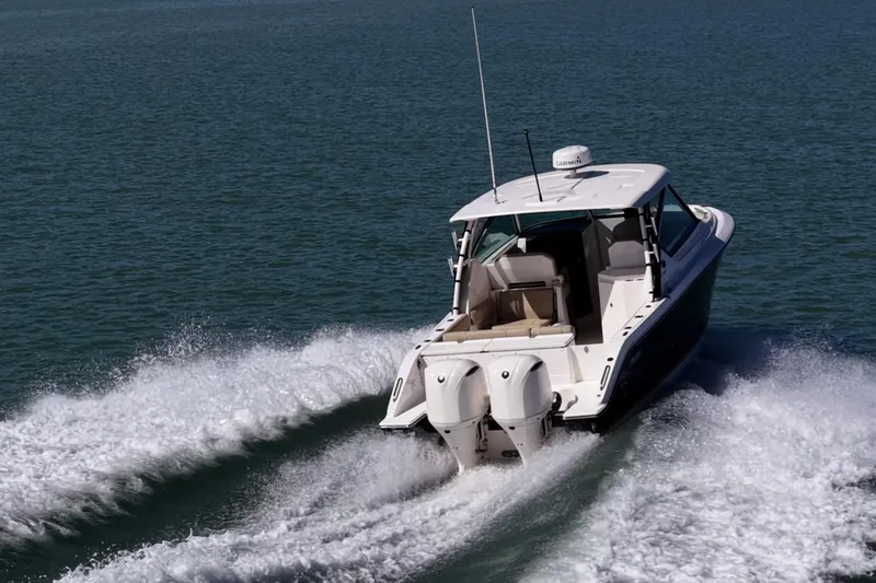 Slide: The Image of 2017 Pursuit DC 295 Dual Console boat cruising on open water. - 60