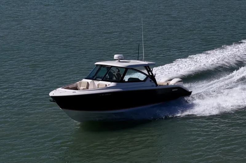 Slide: The Image of 2017 Pursuit DC 295 Dual Console boat cruising on open water. - 62