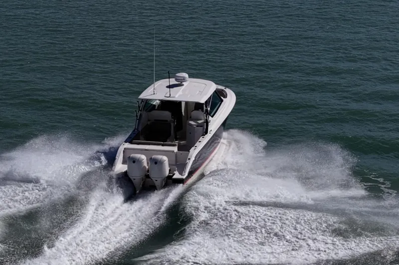 Slide: The Image of 2017 Pursuit DC 295 Dual Console boat cruising on open water. - 66