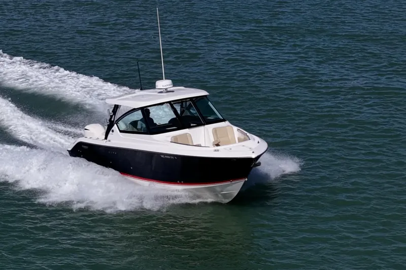 Slide: The Image of 2017 Pursuit DC 295 Dual Console boat cruising on open water. - 73